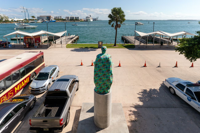 Joiri Minaya, The Cloaking of the statue of Christopher Columbus behind the Bayfront Park Amphitheatre, Miami, Florida, 2019. dye-sublimation print on spandex fabric and wood scructure. Photos by Zachary Balber, commissioned by Fringe Projects Miami. Courtesy of the artist.