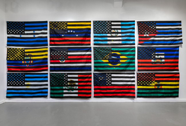 Eddy A. Lpez (b. 1978, Matagalpa, Nicaragua), In-Dependencia, 2021-2022. silkscreen, acrylic on fabric. dimensions variable: each of 16 flags is 3 x 5 feet. Courtesy of the artist.